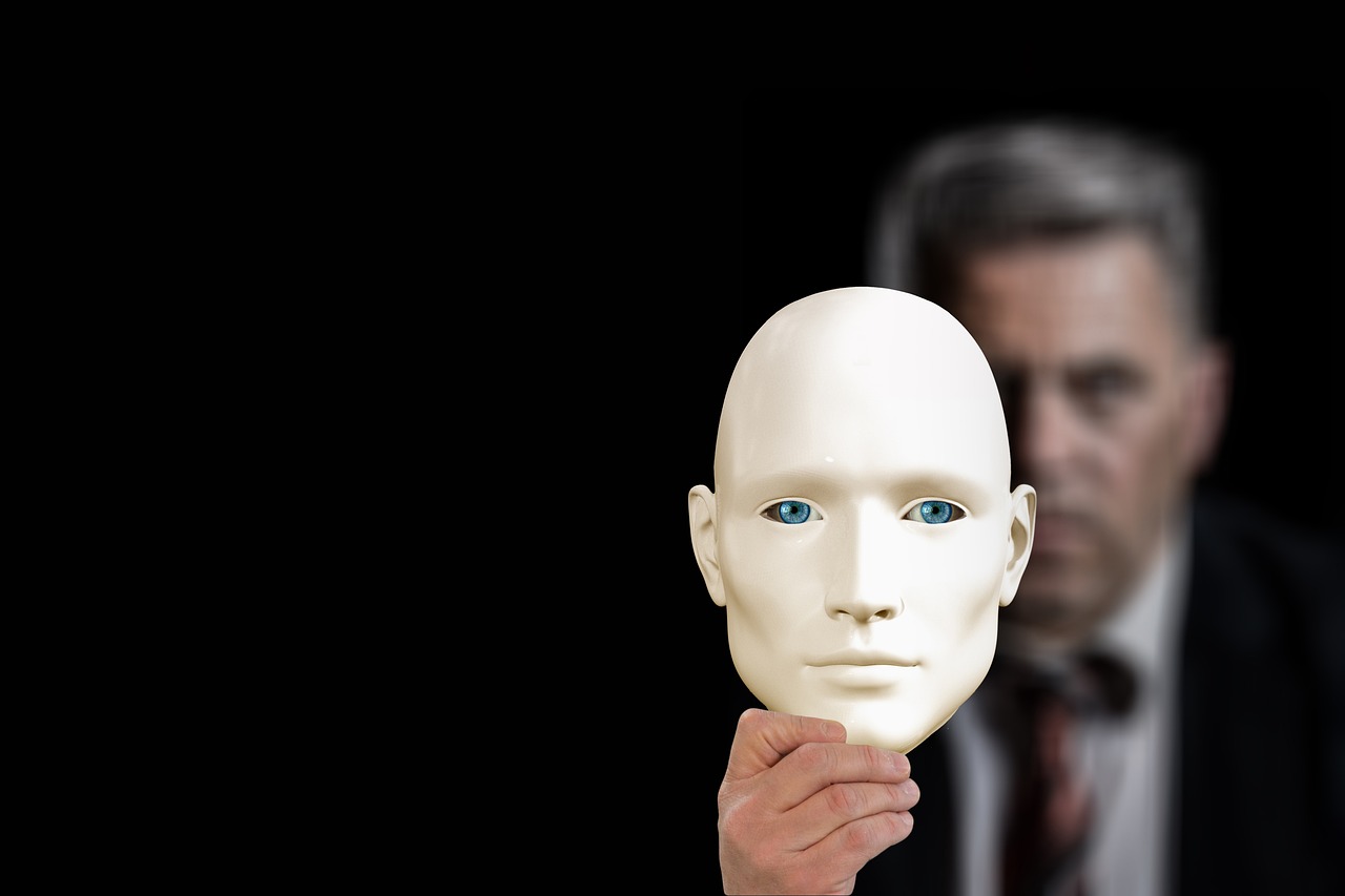 business man holding mask